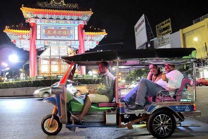 Private Bangkok Night City Tour by Tuk-Tuk with Thai Food - Grand Palace pass-by: the light-up background shot