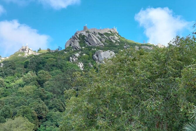 Private Tour Sintra, Palaces and Mountain Tuk Tuk(2 to 6 people) - Pena Palace at the top: bright colors, crowd management, and quick legend talk